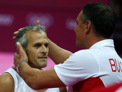 Bulgaria's Jordan Jovtchev is seen with his coach at the men's gymnastics rings final in the North Greenwich Arena during the London 2012 Ol Bulgaria's Jordan Jovtchev is seen with his coach at the men's gymnastics rings final in the North Greenwich Arena during the London 2012 Ol