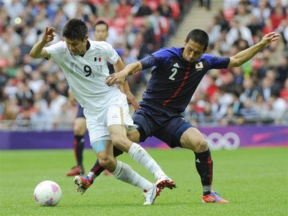 Mexico's Oribe Peralta fights for the ball with Japan's Yuhei Tokunaga (R) during their men's semi-final soccer match at Wembley Stadium in Mexico's Oribe Peralta fights for the ball with Japan's Yuhei Tokunaga (R) during their men's semi-final soccer match at Wembley Stadium in