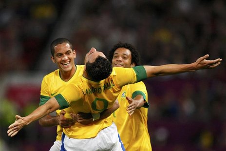 Brazil's Leandro Damiao celebrates with Brazil's Romulo (L) and Marcelo (R) after scoring a goal against South Korea during their men's semi Brazil's Leandro Damiao celebrates with Brazil's Romulo (L) and Marcelo (R) after scoring a goal against South Korea during their men's semi