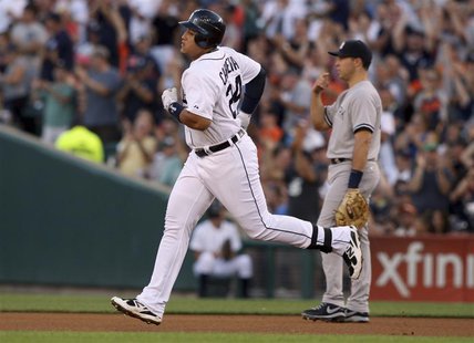 Detroit Tigers Miguel Cabrera (L) passes New York Yankees first baseman Mark Teixeira as he rounds the bases after hitting a solo home run d Detroit Tigers Miguel Cabrera (L) passes New York Yankees first baseman Mark Teixeira as he rounds the bases after hitting a solo home run d