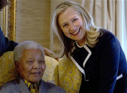 U.S. Secretary of State Hillary Rodham Clinton poses for a photograph with Nelson Mandela, former president of South Africa, at his home in U.S. Secretary of State Hillary Rodham Clinton poses for a photograph with Nelson Mandela, former president of South Africa, at his home in