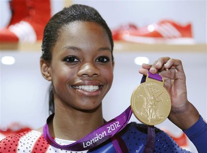 U.S. gymnast Gabby Douglas, 16, poses with her gold medal during a news conference at the 2012 London Olympic Games August 8, 2012. REUTERS/ U.S. gymnast Gabby Douglas, 16, poses with her gold medal during a news conference at the 2012 London Olympic Games August 8, 2012. REUTERS/