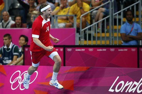 Denmark's Mikkel Hansen celebrates a goal during their men's handball quarterfinal match against Sweden at the Basketball Arena during the L Denmark's Mikkel Hansen celebrates a goal during their men's handball quarterfinal match against Sweden at the Basketball Arena during the L
