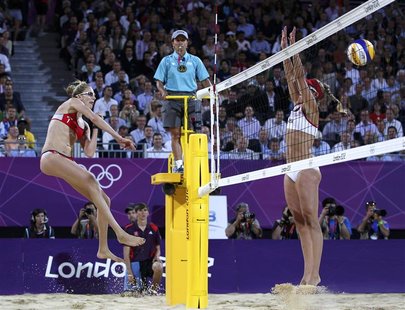 Kerri Walsh Jennings (L) of the U.S. spikes the ball past April Ross of the U.S. at the women's beach volleyball gold medal match at the Hor Kerri Walsh Jennings (L) of the U.S. spikes the ball past April Ross of the U.S. at the women's beach volleyball gold medal match at the Hor