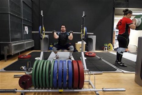 Jorge Garcia Bustos (L) and Maria Valdes Paris, weightlifters from Chile, train at the Athletes' Village at the Olympic Park, July 22, 2012. Jorge Garcia Bustos (L) and Maria Valdes Paris, weightlifters from Chile, train at the Athletes' Village at the Olympic Park, July 22, 2012.