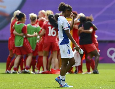 France's Laura George (4) walks off the pitch as Canada celebrates winning the women's bronze medal soccer match in Coventry at City of Cove France's Laura George (4) walks off the pitch as Canada celebrates winning the women's bronze medal soccer match in Coventry at City of Cove