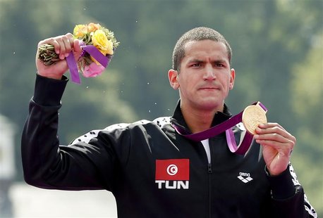Tunisia's Oussama Mellouli poses with his gold medal after the men's 10km marathon swimming at Hyde Park during the London Olympic Games Aug Tunisia's Oussama Mellouli poses with his gold medal after the men's 10km marathon swimming at Hyde Park during the London Olympic Games Aug