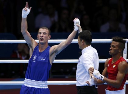 Ireland's John Joe Nevin (L) is declared the winner over Cuba's Lazaro Alvarez Estrada after their Men's Bantam (56kg) semi-final boxing mat Ireland's John Joe Nevin (L) is declared the winner over Cuba's Lazaro Alvarez Estrada after their Men's Bantam (56kg) semi-final boxing mat