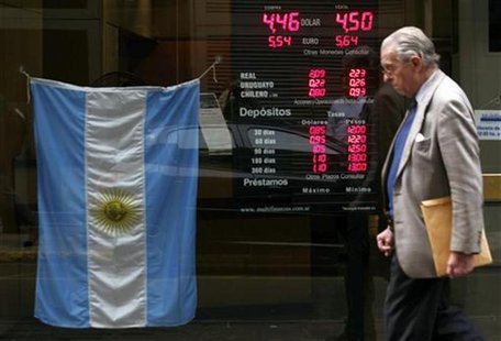 A man walks past an electronic board showing currency exchange rates and an Argentine flag at a money exchange in Buenos Aires, June 1, 2012 A man walks past an electronic board showing currency exchange rates and an Argentine flag at a money exchange in Buenos Aires, June 1, 2012