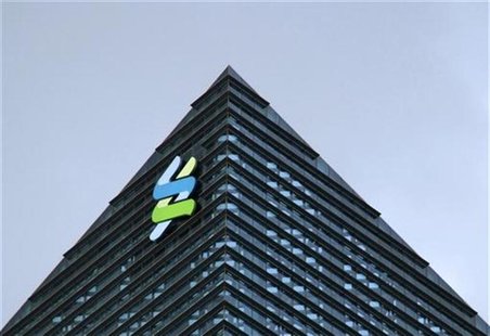 The logo of Standard Chartered is seen at its new Singapore office tower at the Marina Bay Financial Centre, January 24, 2011. REUTERS/Kevin The logo of Standard Chartered is seen at its new Singapore office tower at the Marina Bay Financial Centre, January 24, 2011. REUTERS/Kevin