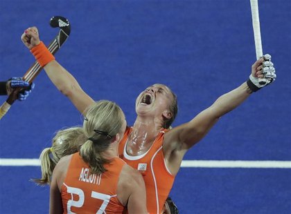 Netherlands' Maartje Paumen (R) with team mates celebrates her scoring a goal against Argentina during their women's gold medal hockey match Netherlands' Maartje Paumen (R) with team mates celebrates her scoring a goal against Argentina during their women's gold medal hockey match