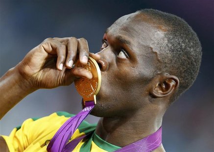 Jamaica's Usain Bolt kisses his gold medal during the presentation ceremony for the men's 200m event at the London 2012 Olympic Games at the Jamaica's Usain Bolt kisses his gold medal during the presentation ceremony for the men's 200m event at the London 2012 Olympic Games at the