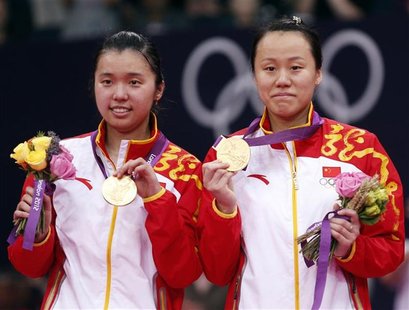 Gold medallists China's Tian Qing (L) and Zhao Yunlei pose at the women's doubles badminton victory ceremony at the London 2012 Olympic Game Gold medallists China's Tian Qing (L) and Zhao Yunlei pose at the women's doubles badminton victory ceremony at the London 2012 Olympic Game