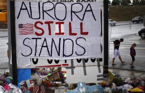 A sign is seen at a memorial for the theater-goers killed in the July 20, 2012 mass shooting, in Aurora, Colorado July 27, 2012. REUTERS/Ric A sign is seen at a memorial for the theater-goers killed in the July 20, 2012 mass shooting, in Aurora, Colorado July 27, 2012. REUTERS/Ric
