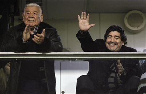 Argentine soccer legend Diego Maradona, coach of UAE's Al Wasl, waves next to his father, Diego Maradona Snr, as they wait for the start of Argentine soccer legend Diego Maradona, coach of UAE's Al Wasl, waves next to his father, Diego Maradona Snr, as they wait for the start of