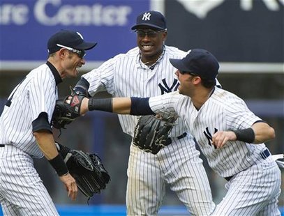 New York Yankees right fielder Ichiro Suzuki (L-R), center fielder Curtis Granderson and right fielder Nick Swisher celebrate after beating New York Yankees right fielder Ichiro Suzuki (L-R), center fielder Curtis Granderson and right fielder Nick Swisher celebrate after beating