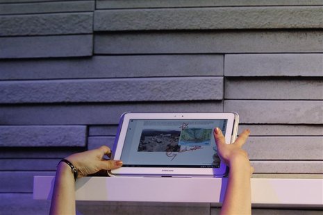 A Samsung employee reaches up to display a Samsung Galaxy Note 10.1 at an unveiling event in New York August 15, 2012. REUTERS/Lucas Jackson A Samsung employee reaches up to display a Samsung Galaxy Note 10.1 at an unveiling event in New York August 15, 2012. REUTERS/Lucas Jackson