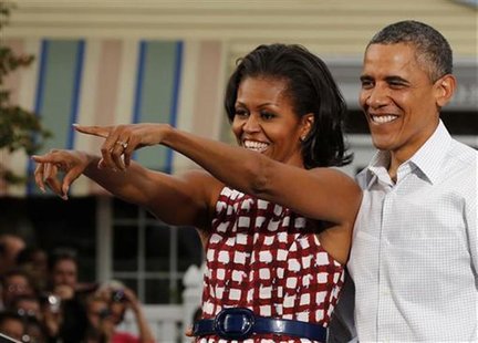 U.S. President Barack Obama is joined on stage by the first lady, Michelle Obama, after he speaks at a campaign event at the Village of East U.S. President Barack Obama is joined on stage by the first lady, Michelle Obama, after he speaks at a campaign event at the Village of East