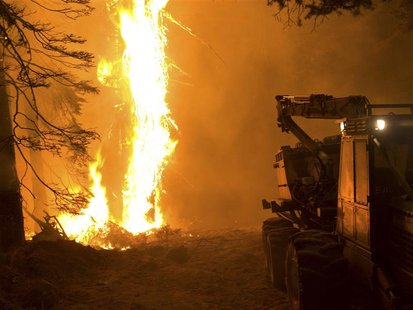 A U.S. Forest Service equipment trailer is seen beside a wildfire at the Springs Fire in Boise National Forest near Banks-Garden Valley, Ida A U.S. Forest Service equipment trailer is seen beside a wildfire at the Springs Fire in Boise National Forest near Banks-Garden Valley, Ida