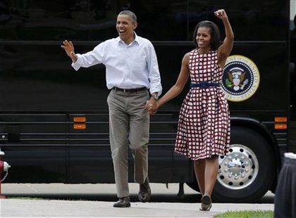 U.S. President Barack Obama and first lady Michelle Obama arrive by bus to speak at a campaign event at the Alliant Energy Amphitheater in D U.S. President Barack Obama and first lady Michelle Obama arrive by bus to speak at a campaign event at the Alliant Energy Amphitheater in D