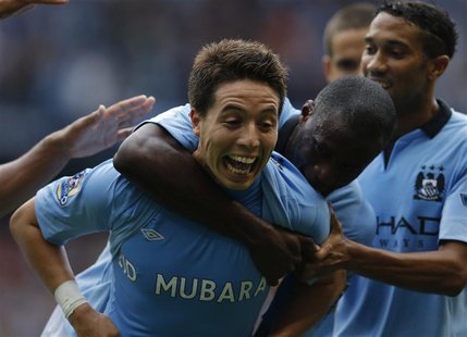 Manchester City's Samir Nasri (L) celebrates with Yaya Toure after scoring his side's third goal during their English Premier League soccer Manchester City's Samir Nasri (L) celebrates with Yaya Toure after scoring his side's third goal during their English Premier League soccer