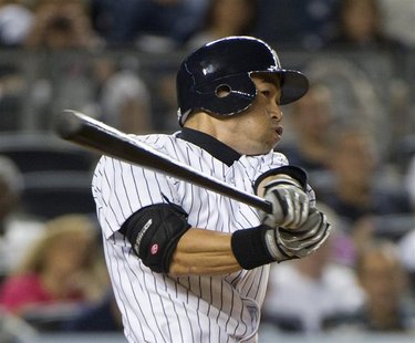 New York Yankees batter Ichiro Suzuki follows through on his swing as he hits a home run against the Boston Red Sox in the fourth inning of New York Yankees batter Ichiro Suzuki follows through on his swing as he hits a home run against the Boston Red Sox in the fourth inning of