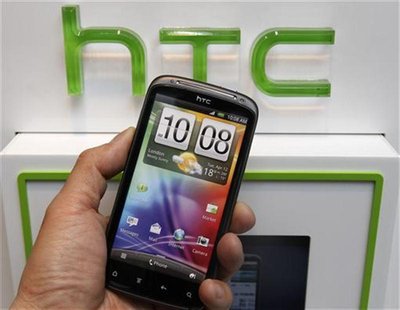 A man poses with a replica of the HTC smartphone inside a mobile phone shop in Taipei April 6, 2012. REUTERS/Shengfa Lin A man poses with a replica of the HTC smartphone inside a mobile phone shop in Taipei April 6, 2012. REUTERS/Shengfa Lin