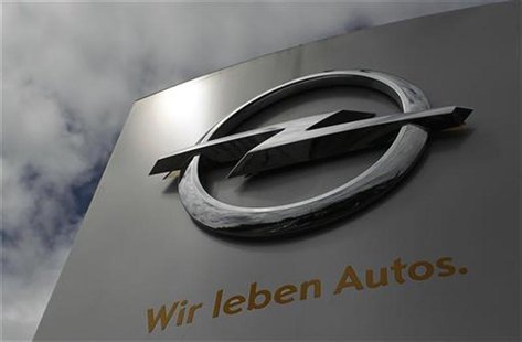 The logo German car manufacturer Opel with its promotional slogan " We live cars" is pictured at the headquarters in Ruesselsheim July 17, 2 The logo German car manufacturer Opel with its promotional slogan " We live cars" is pictured at the headquarters in Ruesselsheim July 17, 2