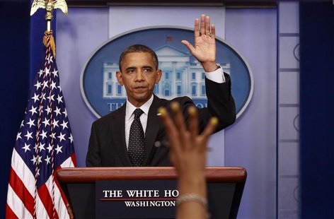 A reporter's hand goes up as U.S. President Barack Obama concludes remarks from the Briefing Room of the White House in Washington August 20 A reporter's hand goes up as U.S. President Barack Obama concludes remarks from the Briefing Room of the White House in Washington August 20