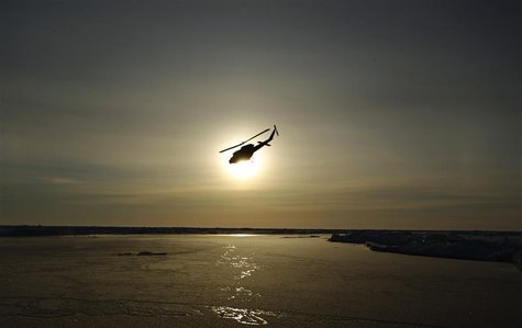 A helicopter flies over Arctic ice towards the Applied Physics Laboratory Ice Station (APLS) during an exercise near the 2011 APLS camp nort A helicopter flies over Arctic ice towards the Applied Physics Laboratory Ice Station (APLS) during an exercise near the 2011 APLS camp nort