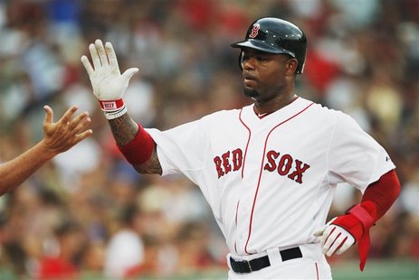 Boston Red Sox Carl Crawford slaps hands with a teammate after scoring a run against the Chicago White Sox during the first inning of Americ Boston Red Sox Carl Crawford slaps hands with a teammate after scoring a run against the Chicago White Sox during the first inning of Americ