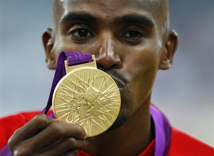 Britain's Mo Farah kisses his gold medal for the men's 5000m at the victory ceremony at the London 2012 Olympic Games at the Olympic Stadium Britain's Mo Farah kisses his gold medal for the men's 5000m at the victory ceremony at the London 2012 Olympic Games at the Olympic Stadium