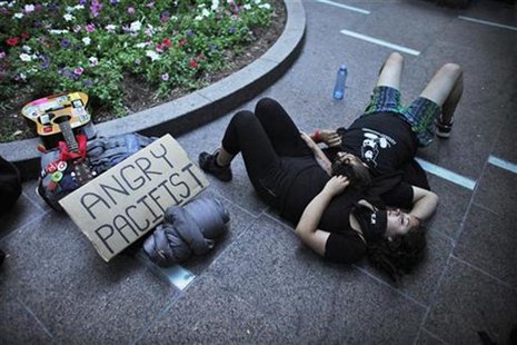 Occupy Wall Street activists rest during a protest at Zuccotti Park in New York July 11, 2012. REUTERS/Eduardo Munoz Occupy Wall Street activists rest during a protest at Zuccotti Park in New York July 11, 2012. REUTERS/Eduardo Munoz