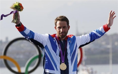 Gold medallist Britain's Ben Ainslie waves during the men's finn class one person dinghy (heavyweight) sailing medal race victory ceremony a Gold medallist Britain's Ben Ainslie waves during the men's finn class one person dinghy (heavyweight) sailing medal race victory ceremony a