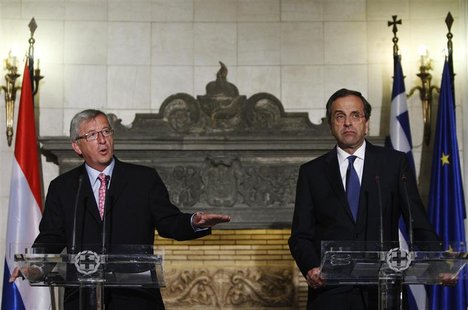 Luxembourg's Prime Minister and Eurogroup Chairman Jean-Claude Juncker (L) gestures next to Greece's Prime Minister Antonis Samaras during a Luxembourg's Prime Minister and Eurogroup Chairman Jean-Claude Juncker (L) gestures next to Greece's Prime Minister Antonis Samaras during a