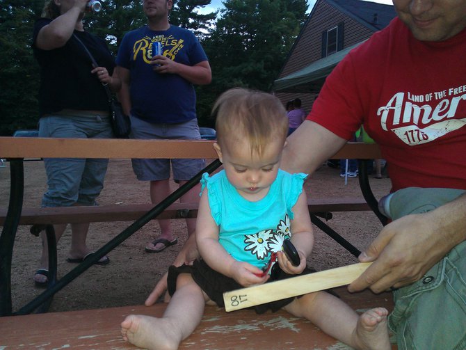 Mia holding my paddles for the Fishin' for a Cure Paddle Raffles
