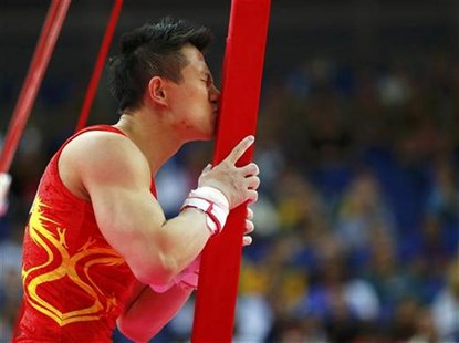 China's Chen Yibing kisses the apparatus after competing in the men's gymnastics rings final in the North Greenwich Arena during the London China's Chen Yibing kisses the apparatus after competing in the men's gymnastics rings final in the North Greenwich Arena during the London