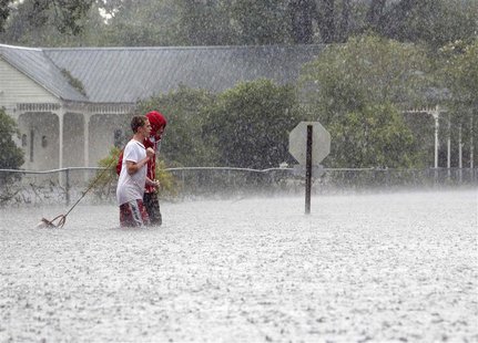Residents of Mandeville walk through a flooded street as Hurricane Isaac passes through Mandeville, Louisiana, August 30, 2012. REUTERS/Jona Residents of Mandeville walk through a flooded street as Hurricane Isaac passes through Mandeville, Louisiana, August 30, 2012. REUTERS/Jona