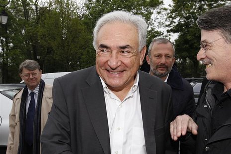Former IMF head Dominique Strauss-Kahn (C) and Francois Pupponi (2ndR), Deputy Mayor of Sarcelles arrive at a polling station in the second Former IMF head Dominique Strauss-Kahn (C) and Francois Pupponi (2ndR), Deputy Mayor of Sarcelles arrive at a polling station in the second
