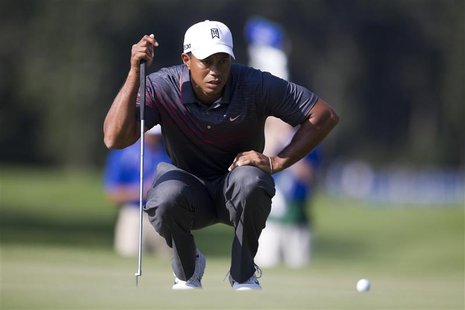 Tiger Woods of the U.S. lines up a putt at the 13th hole during the first round of the Deutsche Bank Championship golf tournament in Norton, Tiger Woods of the U.S. lines up a putt at the 13th hole during the first round of the Deutsche Bank Championship golf tournament in Norton,
