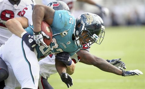 Running back Maurice Jones-Drew of the Jacksonville Jaguars (R) is tackled by the Houston Texans defense during the second half of their NFL Running back Maurice Jones-Drew of the Jacksonville Jaguars (R) is tackled by the Houston Texans defense during the second half of their NFL