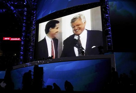Former Massachusetts Governor Mitt Romney (L) is pictured with late Senator Ted Kennedy in a video segment during the first session of the D Former Massachusetts Governor Mitt Romney (L) is pictured with late Senator Ted Kennedy in a video segment during the first session of the D