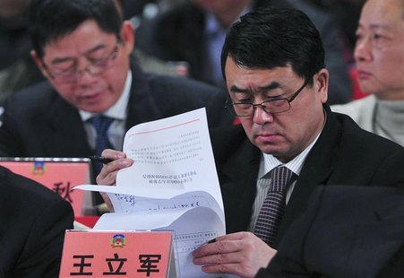 Wang Lijun reads documents as he attends a session of the Chinese People's Political Consultative Conference (CPPCC) of the Chongqing Munici Wang Lijun reads documents as he attends a session of the Chinese People's Political Consultative Conference (CPPCC) of the Chongqing Munici