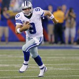 Dallas Cowboys quarterback Tony Romo (9) runs with the ball against the New York Giants during their NFL football game in East Rutherford, N