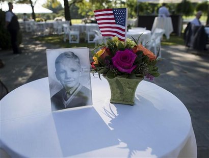 A photograph of Neil Armstrong as a young man is displayed on a table during a memorial service celebrating the life of Armstrong at the Cam A photograph of Neil Armstrong as a young man is displayed on a table during a memorial service celebrating the life of Armstrong at the Cam