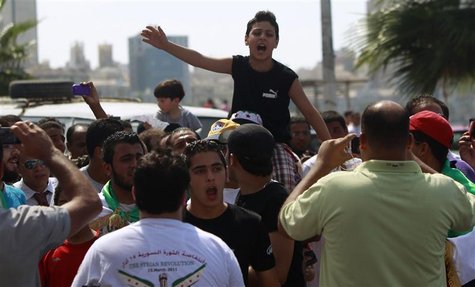 Syrian protesters and Muslim Brotherhood's supporters shout slogans against Syria's President Bashar al-Assad, Iran and Hazeb Allah in the M Syrian protesters and Muslim Brotherhood's supporters shout slogans against Syria's President Bashar al-Assad, Iran and Hazeb Allah in the M