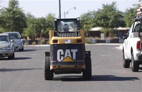 A worker drives a Caterpillar tractor near a construction site in Gilbert, Arizona October 20, 2009. REUTERS/Joshua Lott A worker drives a Caterpillar tractor near a construction site in Gilbert, Arizona October 20, 2009. REUTERS/Joshua Lott