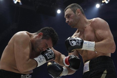 Vitali Klitschko (R) and his challenger Manuel Charr exchange blows during their WBC heavyweight title fight in Moscow September 9, 2012. RE Vitali Klitschko (R) and his challenger Manuel Charr exchange blows during their WBC heavyweight title fight in Moscow September 9, 2012. RE