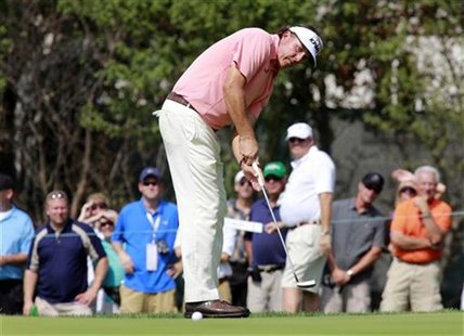Phil Mickelson of the U.S. watches his putt roll on the eleventh green during round one of the BMW Championship golf tournament in Carmel, I Phil Mickelson of the U.S. watches his putt roll on the eleventh green during round one of the BMW Championship golf tournament in Carmel, I