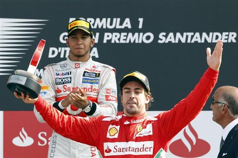 McLaren Formula One driver Lewis Hamilton (L) of Britain, winner of the race, looks at the Ferrari Formula One driver Fernando Alonso of Spa McLaren Formula One driver Lewis Hamilton (L) of Britain, winner of the race, looks at the Ferrari Formula One driver Fernando Alonso of Spa